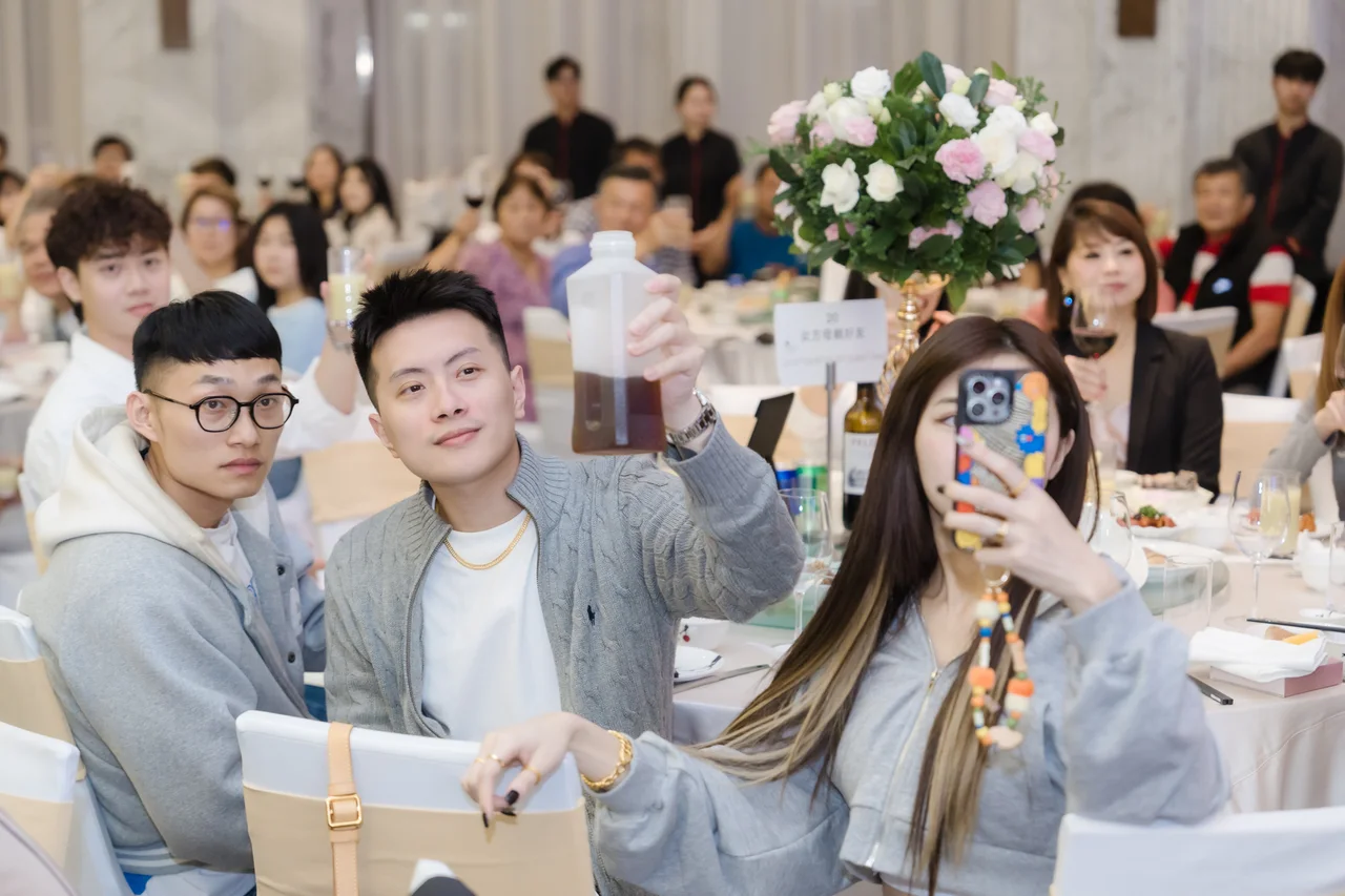 親友在宴席間舉起飲料祝福新人